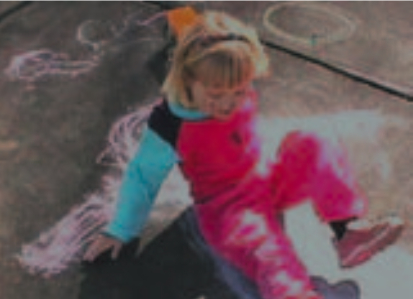 Blond girl lying down on her chalk drawing of a doll