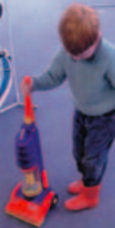 Child using vacuum cleaner