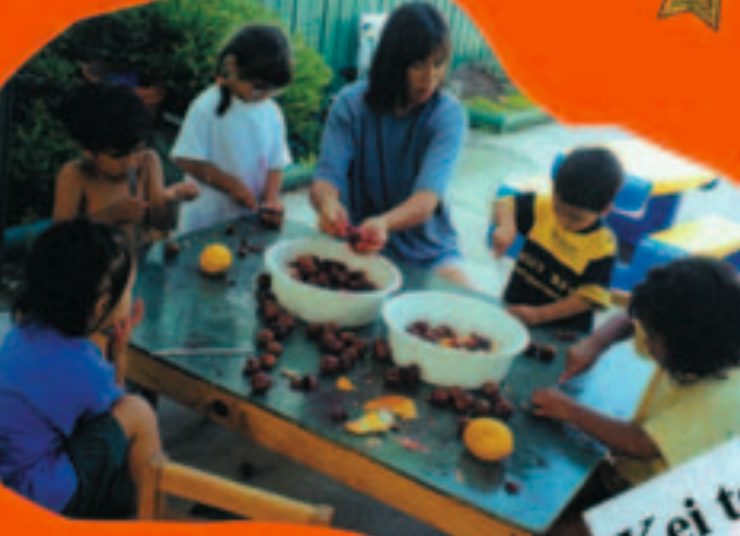 Children and teacher preparing food