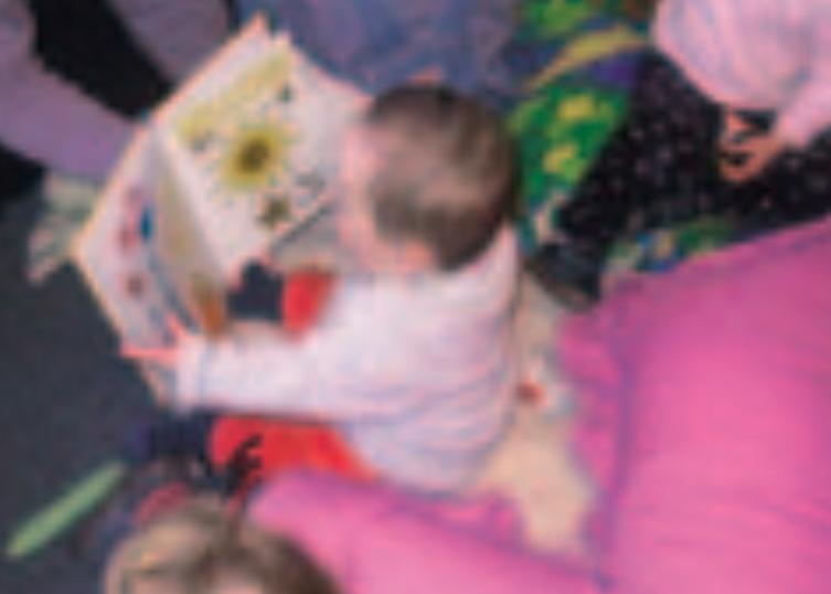 Infant boy looking at picture book