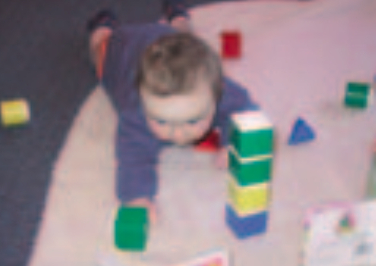 Infant playing with block set