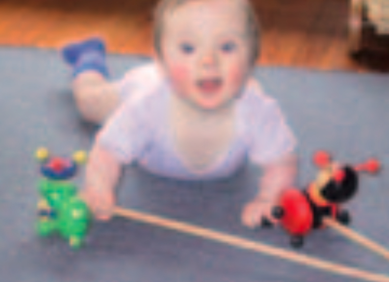 Infant boy playing with toys