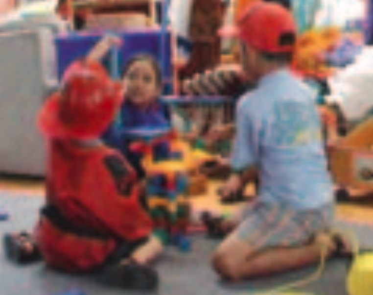Three children playing with toys