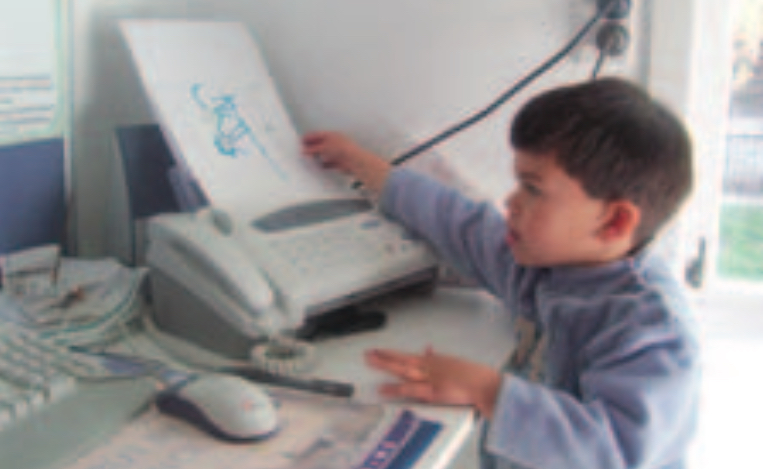 Boy using fax machine