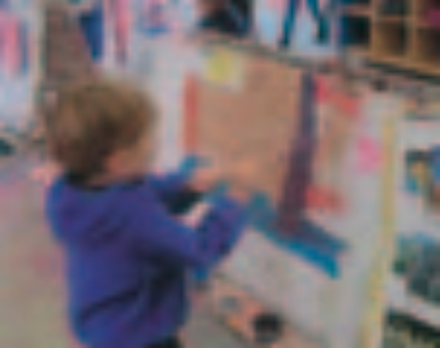 Boy painting a picture of trees