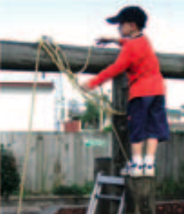 Boy on stepladder making a rope crane