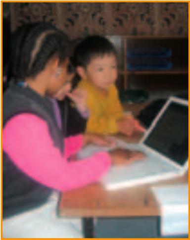 Teacher and chid using laptop
