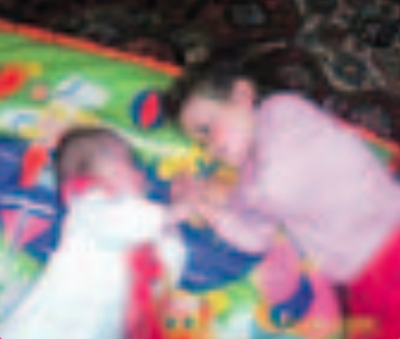 Two infants on a blanket