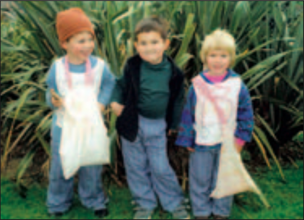 Three children wearing completed sewing project