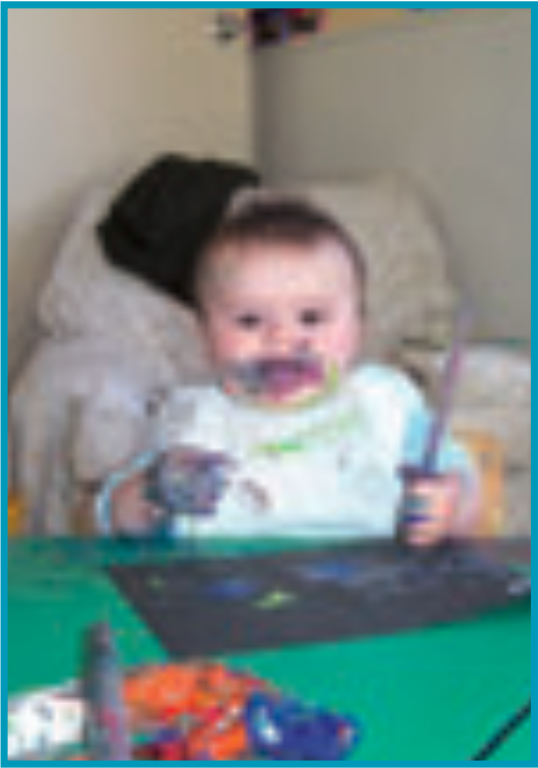 Infant playing with paint