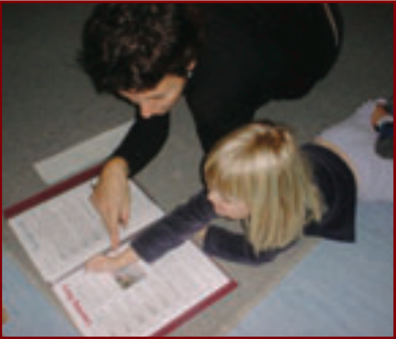 Teacher and child looking at a portfolio