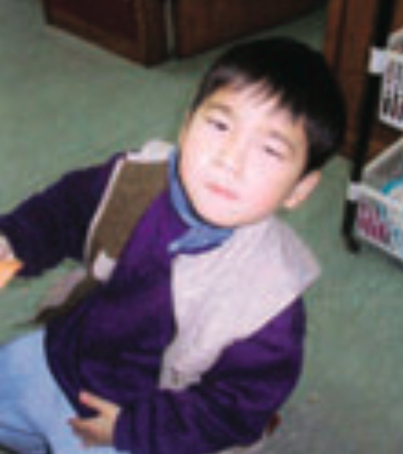 Child wearing purple sweater