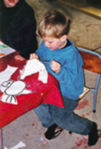 Child creating an animal out of wool
