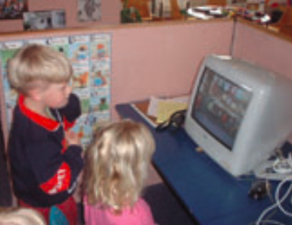 Two children looking at computer screen