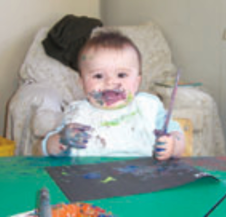 Infant playing with paint