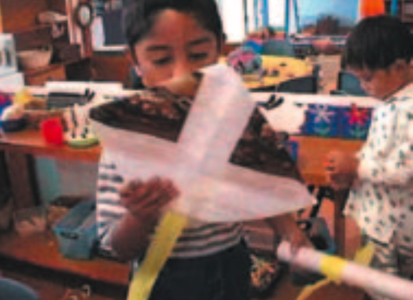 Child fixing a kite