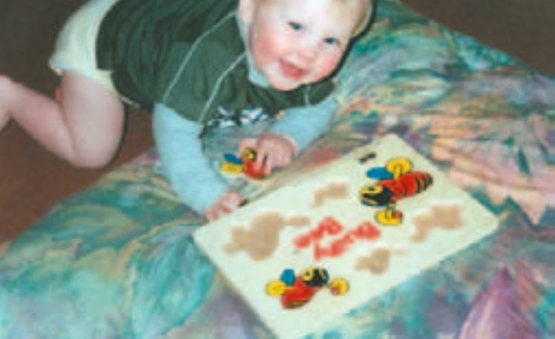 Infant boy doing a puzzle