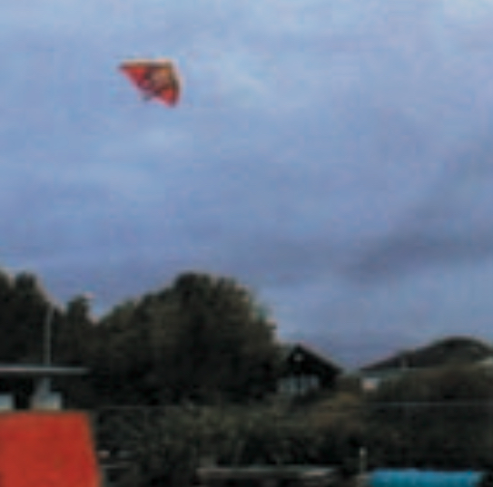 Orange kite, grey sky