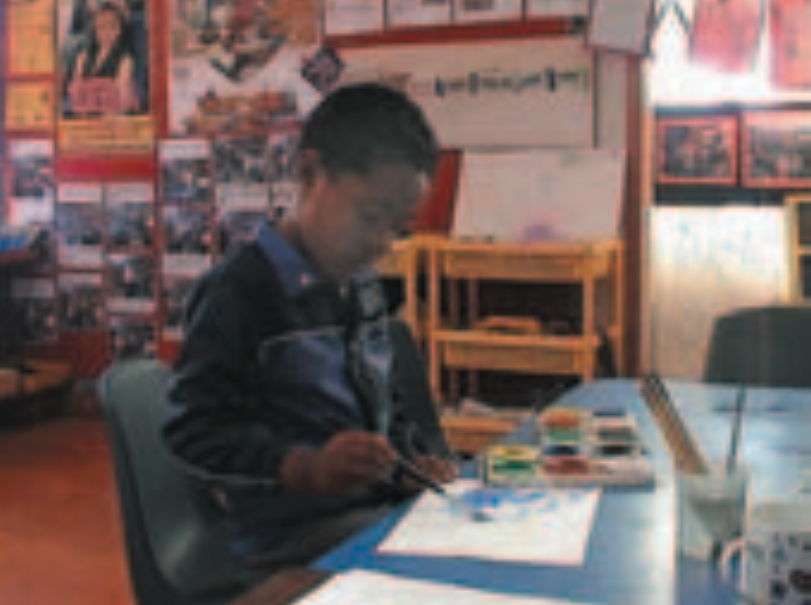 Boy painting in book